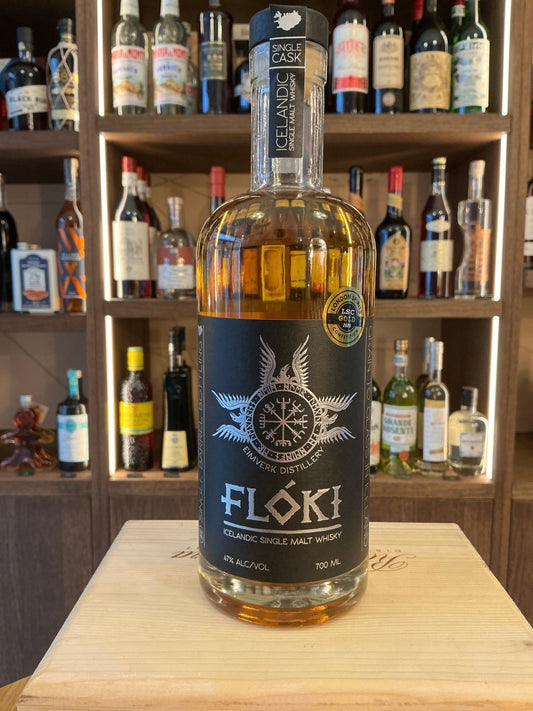 Floki Single Malt 3 Year Iceland whisky bottle with black label, nautical compass design, premium small batch artisan spirit.