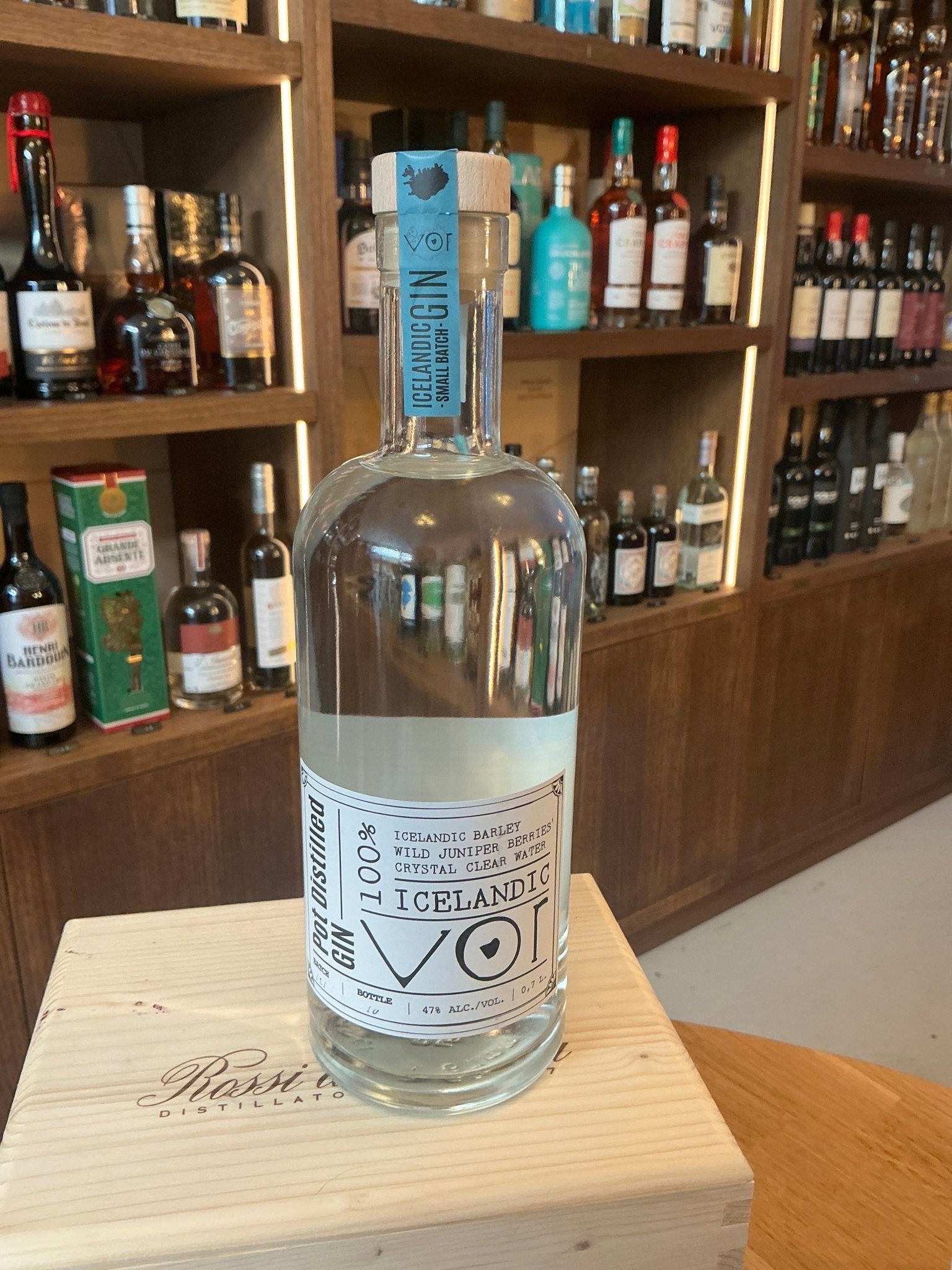Clear glass bottle of For Icelandic Gin with minimalist white and blue label, featuring premium craft Dutch artisanal.