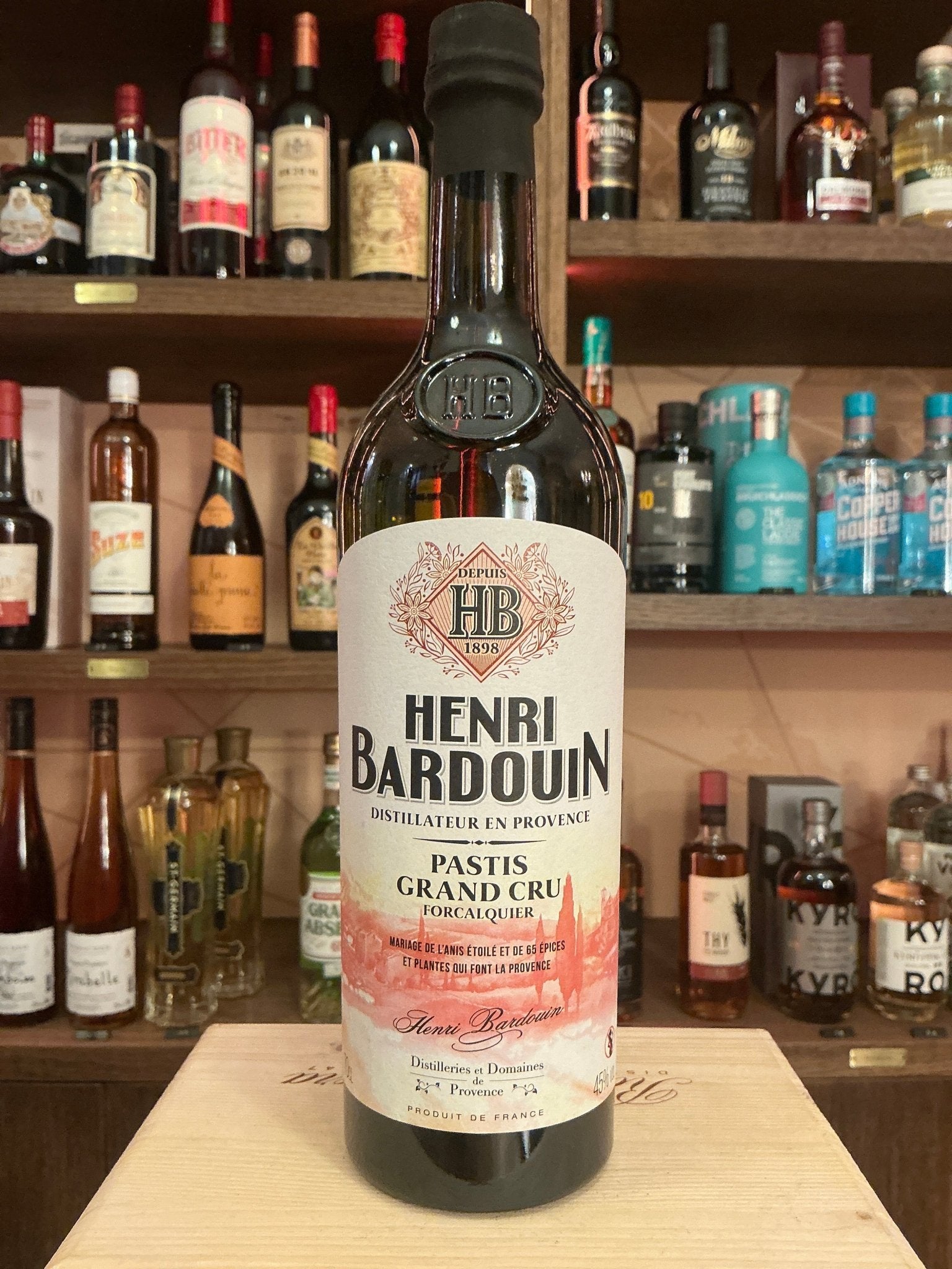 Henri Bardouin Pastis bottle with botanical, spiced French liqueur, premium artisan specialty spirit on wooden shelf.