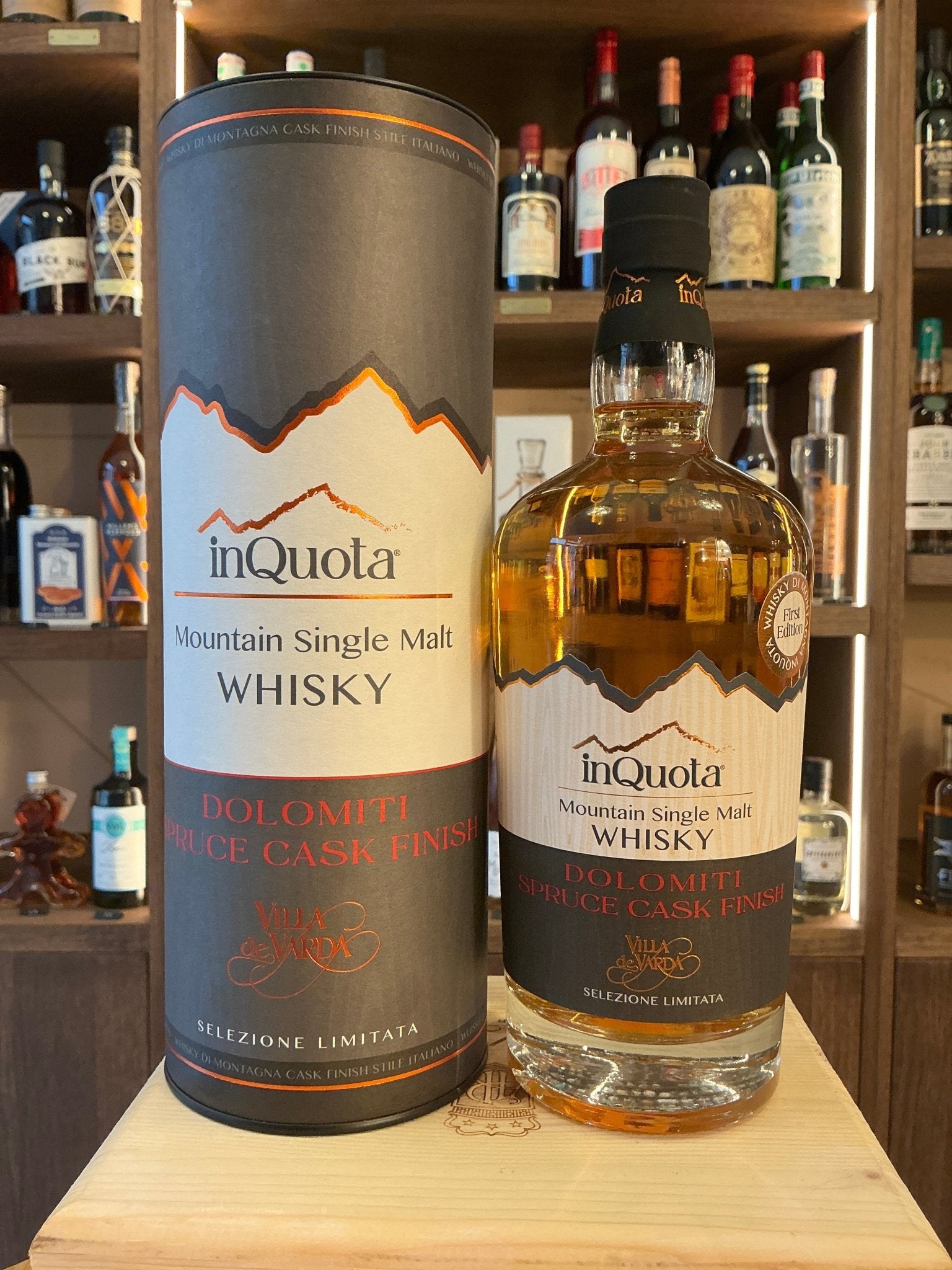 Inquota Mountain Single Malt Whisky bottle with amber liquid, featuring premium aged Italian whisky label, displayed on.