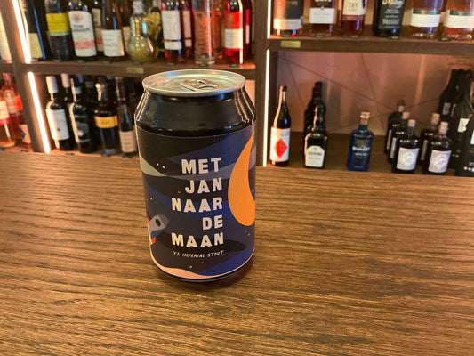 Premium craft beer can labeled Jan Naar De Maan with dark blue and orange design on wooden bar counter, artisan specialty.