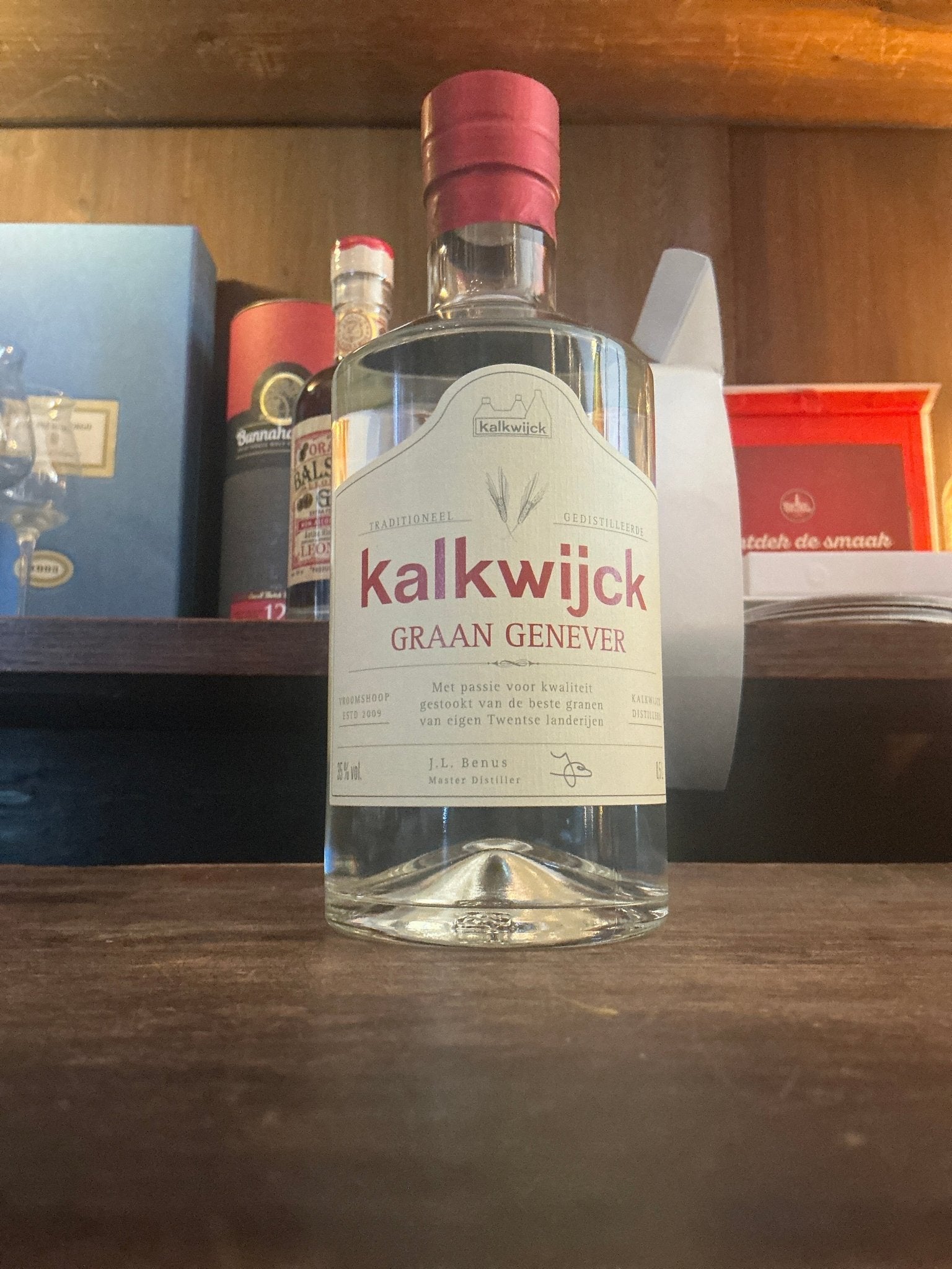 Kalkwijck Jonge Dutch Genever clear glass bottle with red cap, premium distilled artisan spirit.
