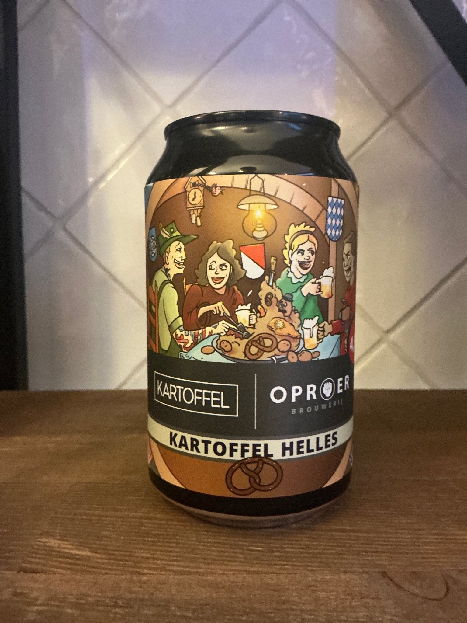 Dutch artisanal craft lager can with vintage-style label featuring festive group, labeled Kartoffel Helles premium limited.