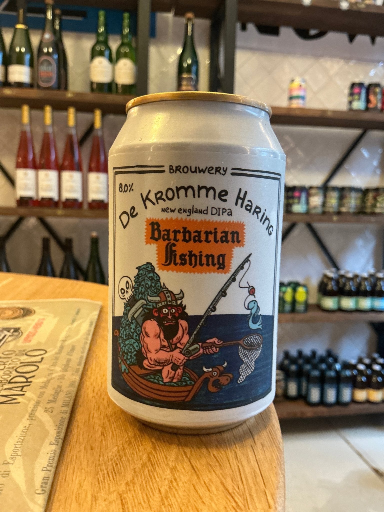 Craft beer can of De Kromme Haring Barbarian Fishing IPA with illustrated barbarian and nautical theme, premium Dutch.