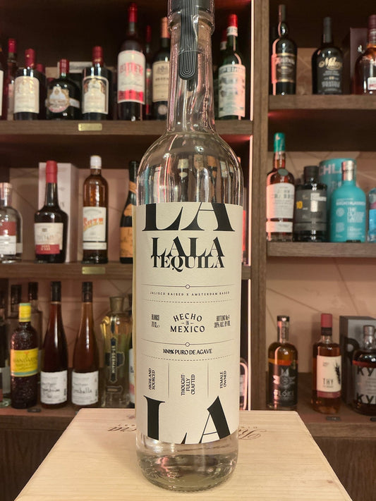 Clear glass bottle of La La Tequila white tequila with minimalist black and white label, premium artisan small-batch spirit, .
