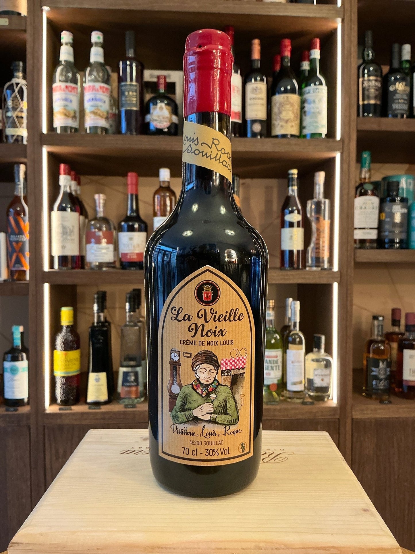 La Vieille Noix walnut liqueur bottle with red wax seal, artisan Dutch small batch premium spirit on wooden surface,.