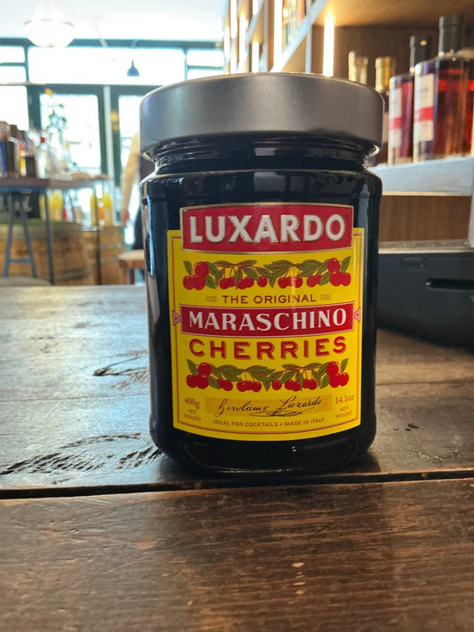Luxardo Maraschino Cherries jar with black lid, red and yellow label, artisanal premium garnish for craft cocktails.