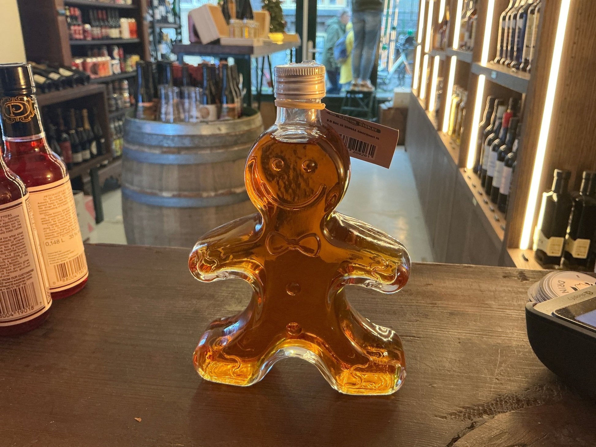 Mannetje Peperkoek spiced Dutch liqueur in gingerbread-shaped glass bottle with amber liquid, artisan small batch specialty.