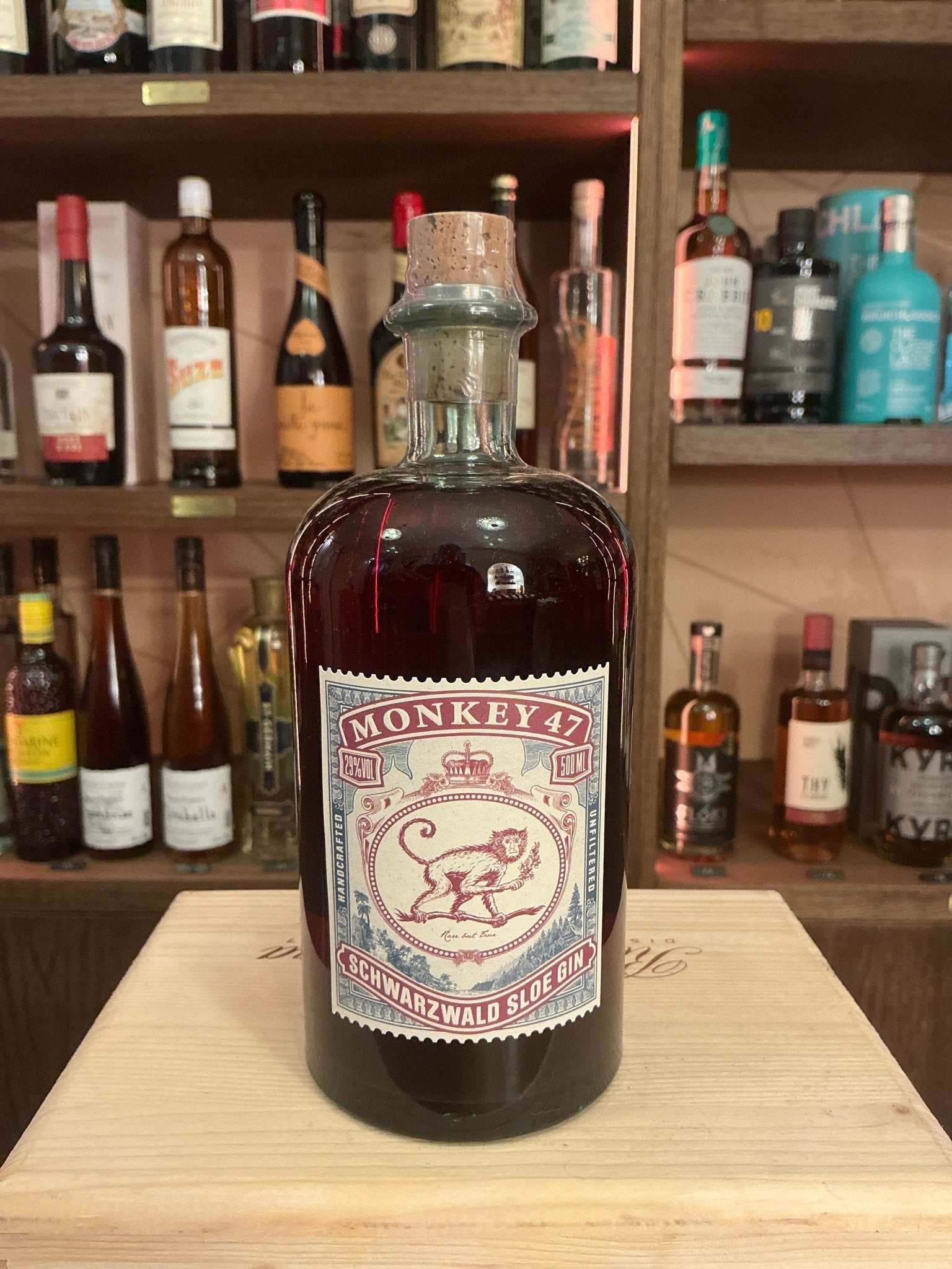 Monkey 47 Sloe Gin bottle with deep red hue, vintage-style label featuring a monkey illustration, premium small-batch.