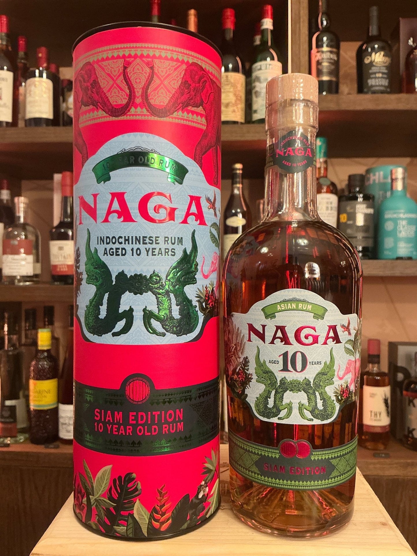 Naga Rum 10 Year Indochinese premium aged dark rum bottle with botanical and spiced notes, featuring vibrant red and green.