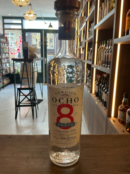 Ocho Blanco Tequila premium clear glass bottle with red number 8 label, small batch artisan distilled spirit.