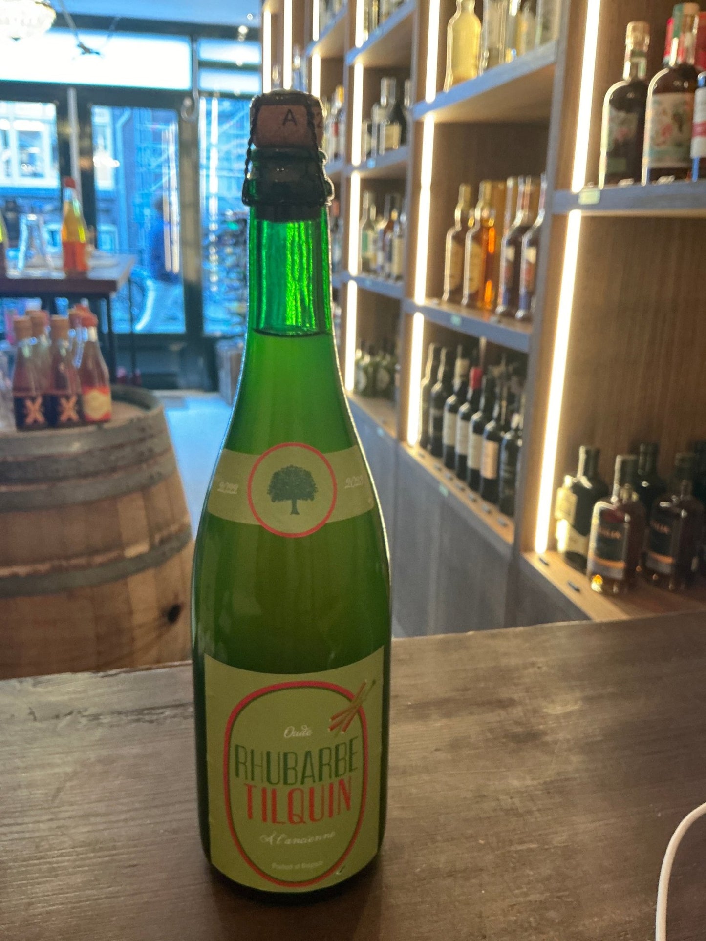 Green glass bottle of Oude Rhubarbe Tilquin à l'Ancienne Belgian lambic craft beer, artisanal small batch specialty spirits.