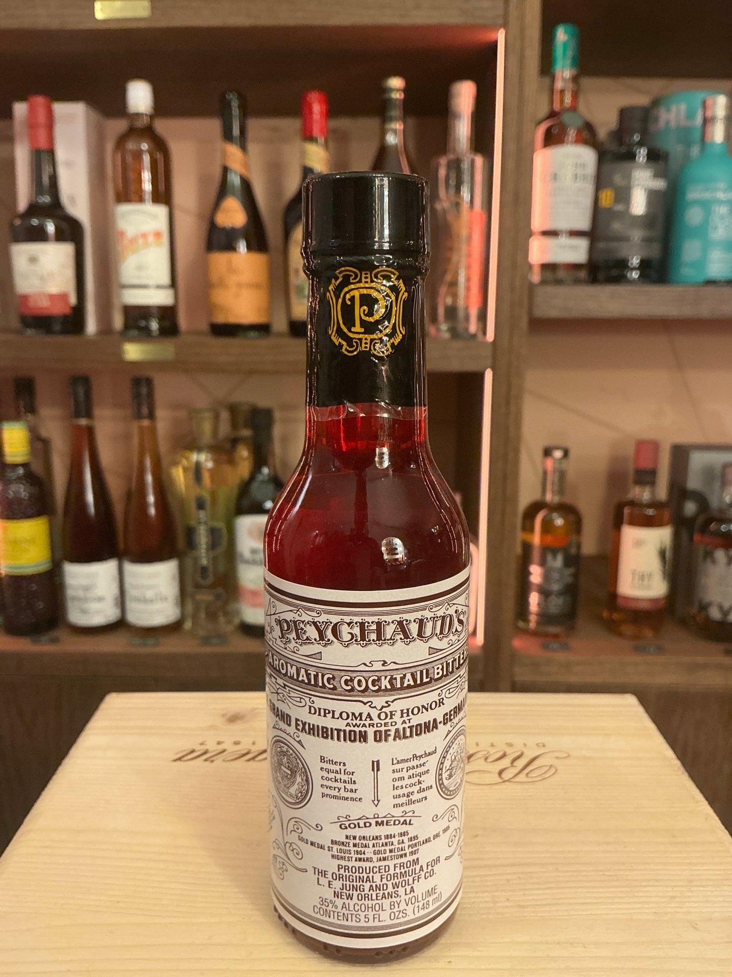 Peychaud’s Bitters bottle with deep red liquid, botanical spiced artisan label, premium small batch specialty spirits for.