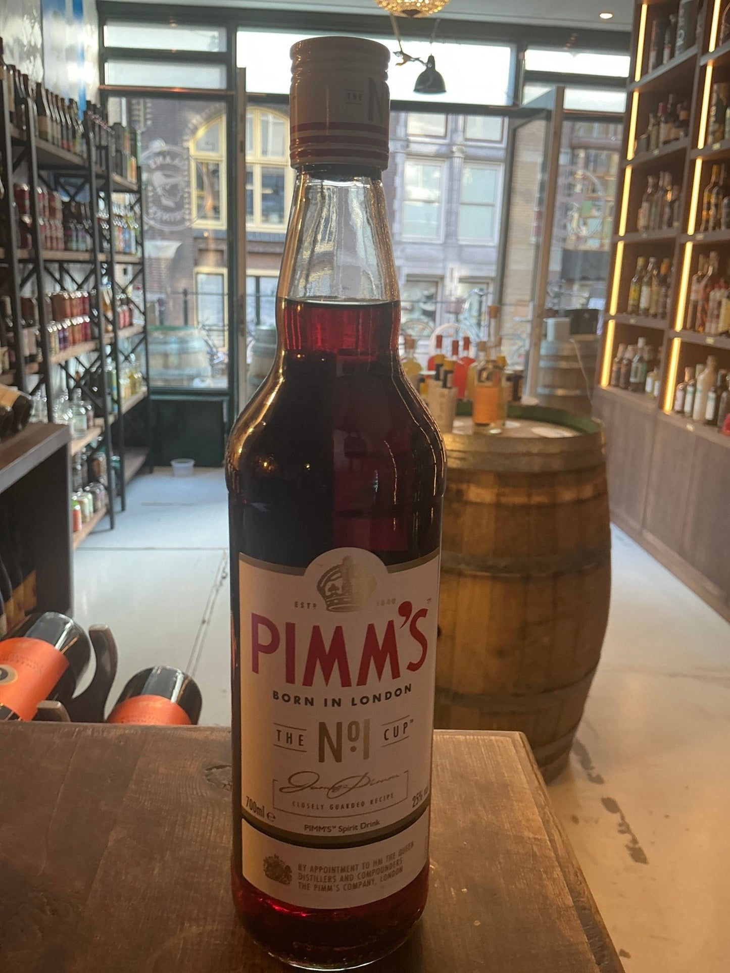 Pimms No.1 Cup premium gin liqueur bottle with botanical spiced flavor, clear glass showcasing rich amber liquid in.