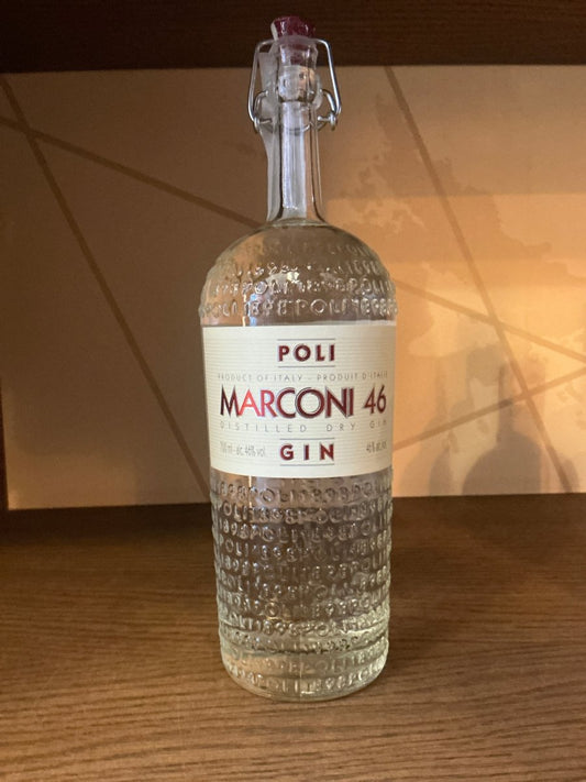 Poli Marconi 46 artisanal distilled gin bottle with textured glass, premium botanical spirit on wooden counter, specialty.
