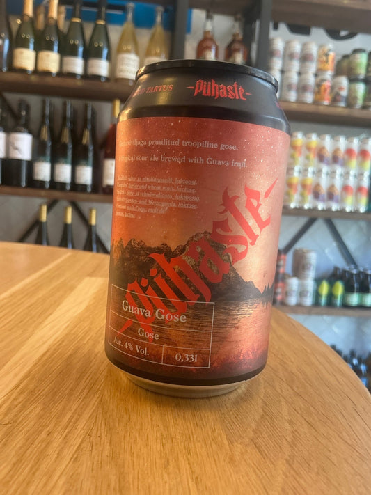 Pühaste Guava Gose craft beer can with orange and brown botanical design on wood surface, specialty sour fruited gose variant.