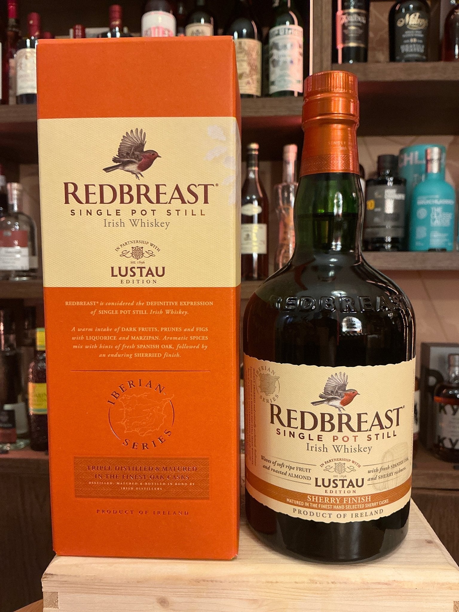 Redbreast Lustau Irish Single Pot Still Whiskey bottle with orange and cream label, next to matching orange box, premium.