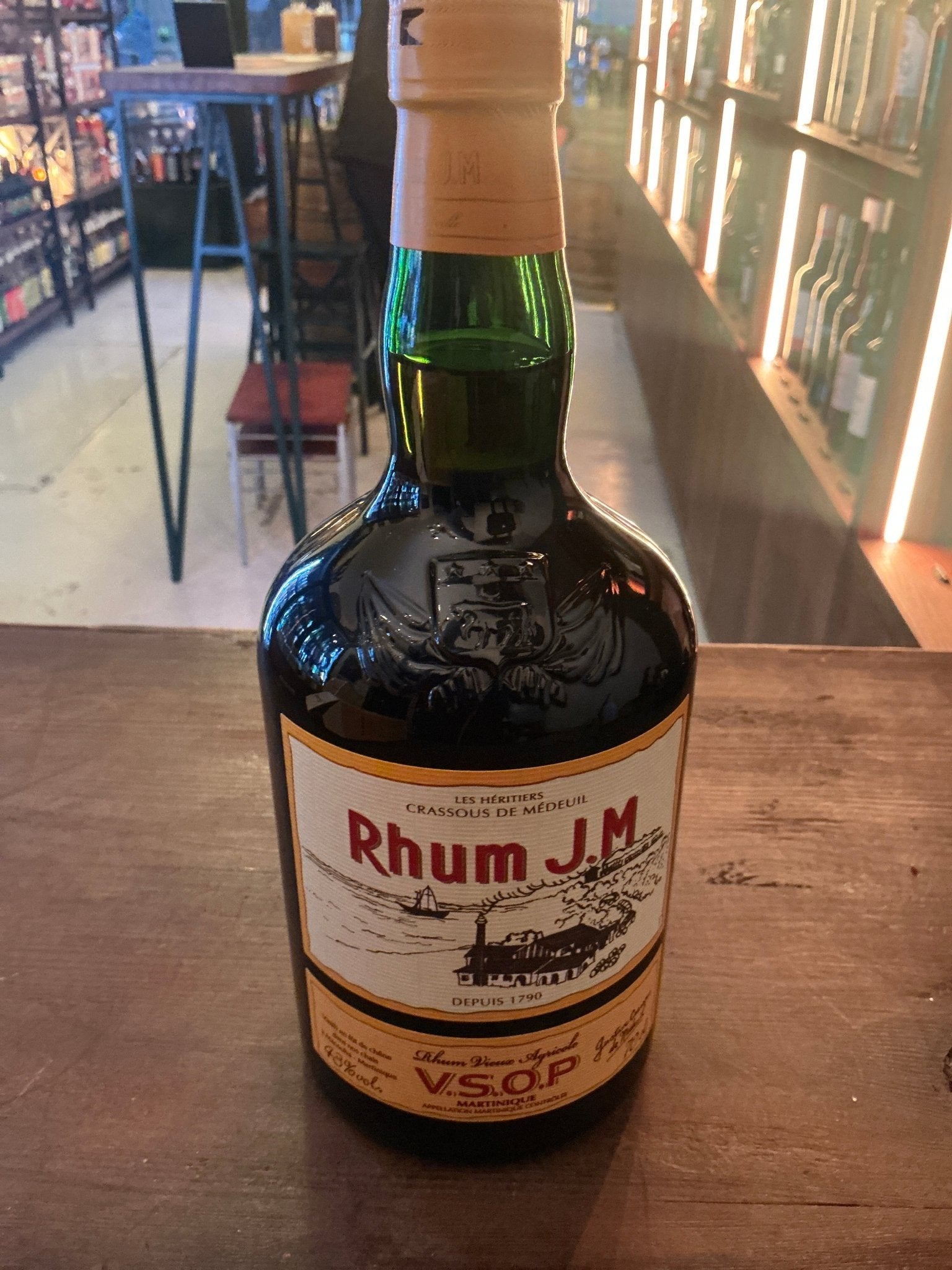 Dark green glass bottle of Rhum J.M V.S.O.P. aged Martinique rum, premium small batch artisan spirit with botanical and.