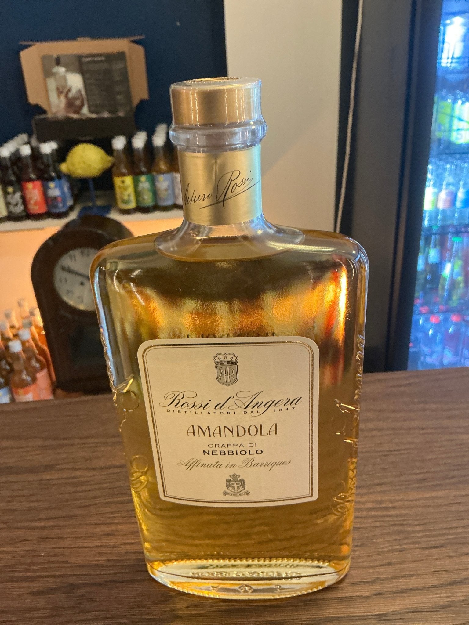 Rossi D’Angera Amandola Nebbiolo grappa bottle with golden amber liquid, premium small batch artisan brandy, distilled and.