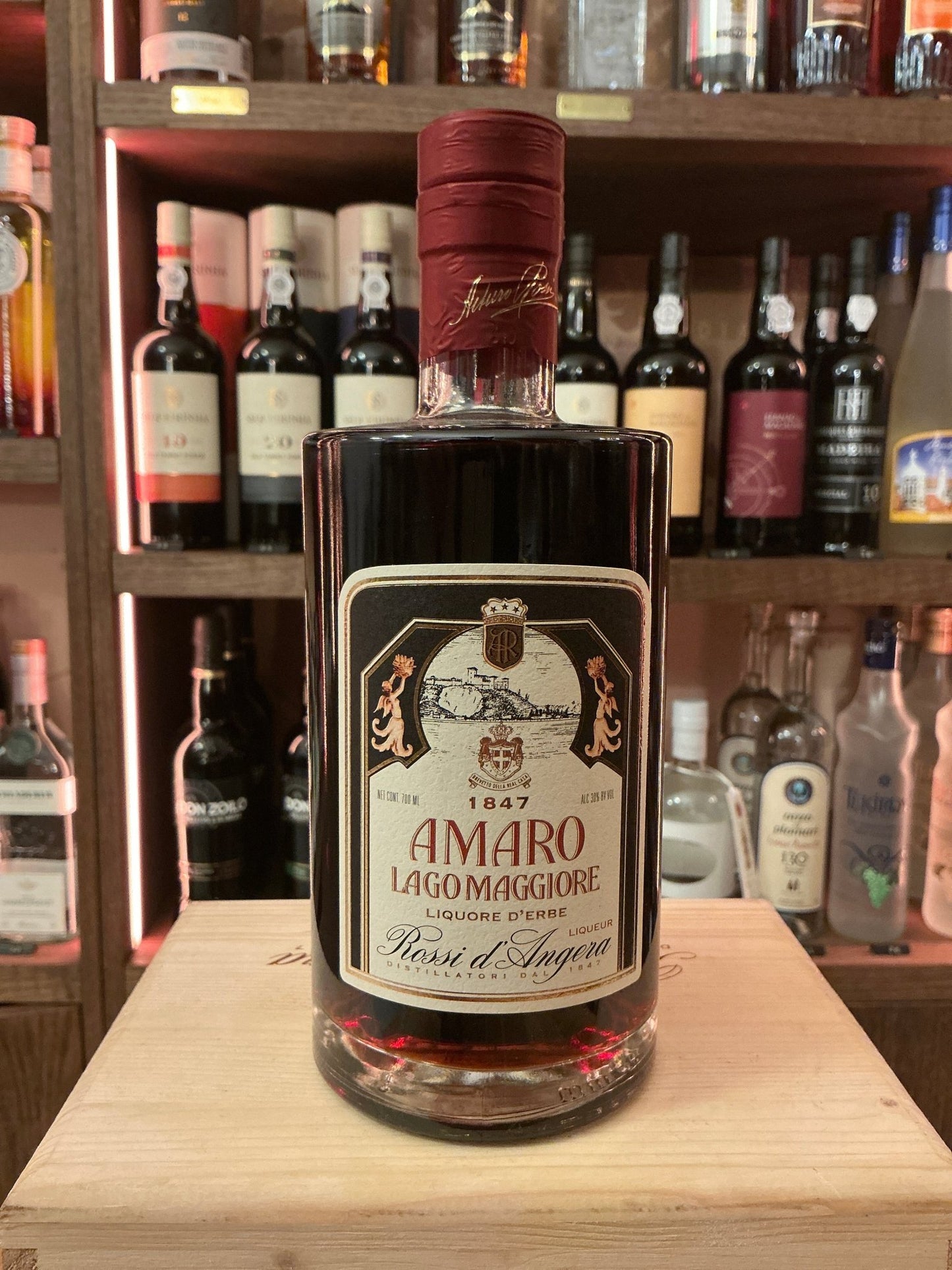 Rossi D'Angera Amaro Lago Maggiore premium spiced botanical liqueur in dark glass bottle with red seal and vintage label.