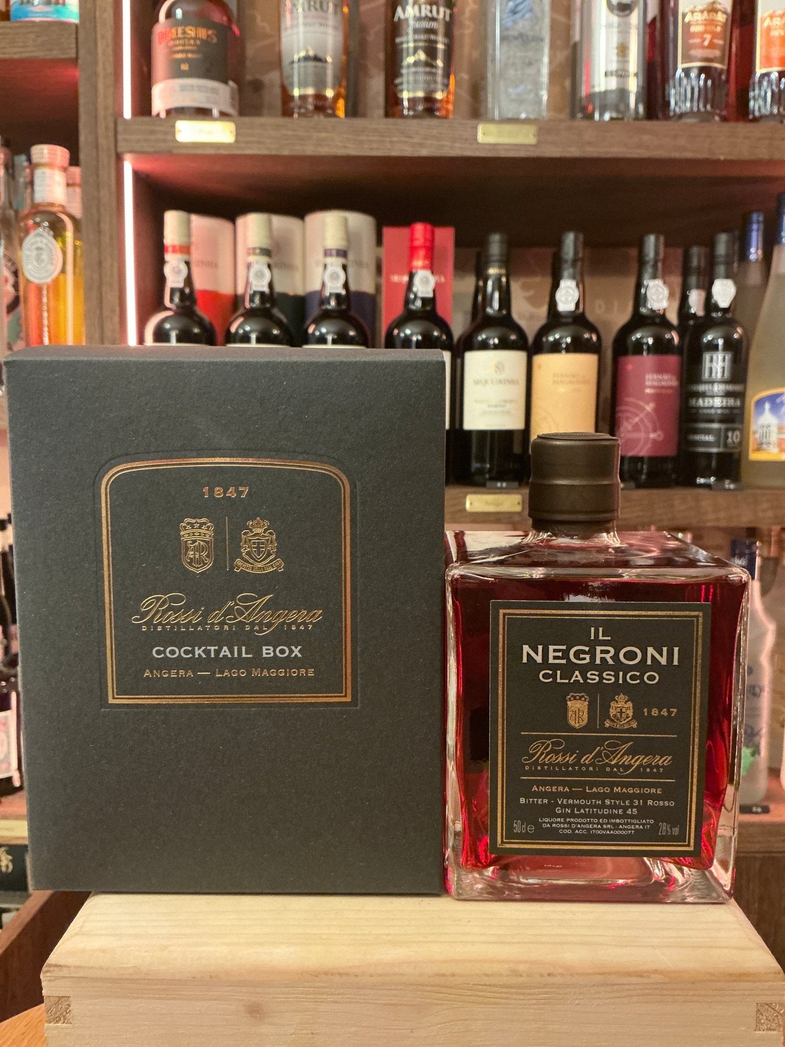 Rossi D'Angera Negroni Classico pre-mixed cocktail bottle with black label, spiced botanical blend, artisan crafted, beside.