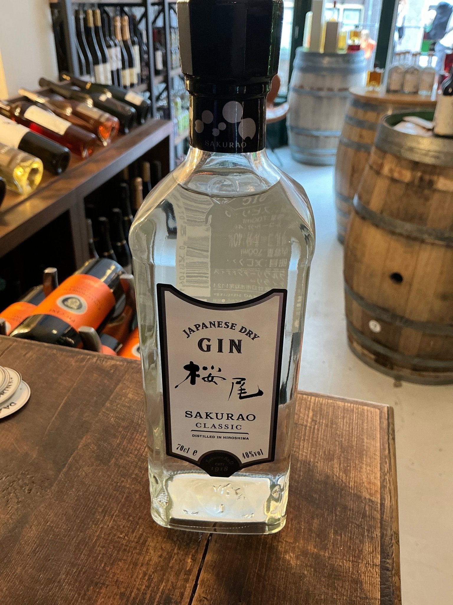 Sakurao Classic Japanese Gin bottle with clear glass, black cap, delicate floral label, artisan small-batch distilled.