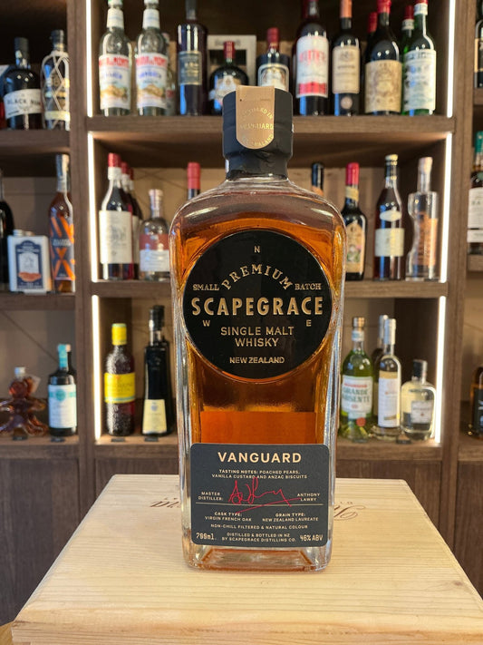 Scapegrace Vanguard single malt whisky bottle with amber liquid, premium Dutch artisan distilled spirits, on wooden surface.