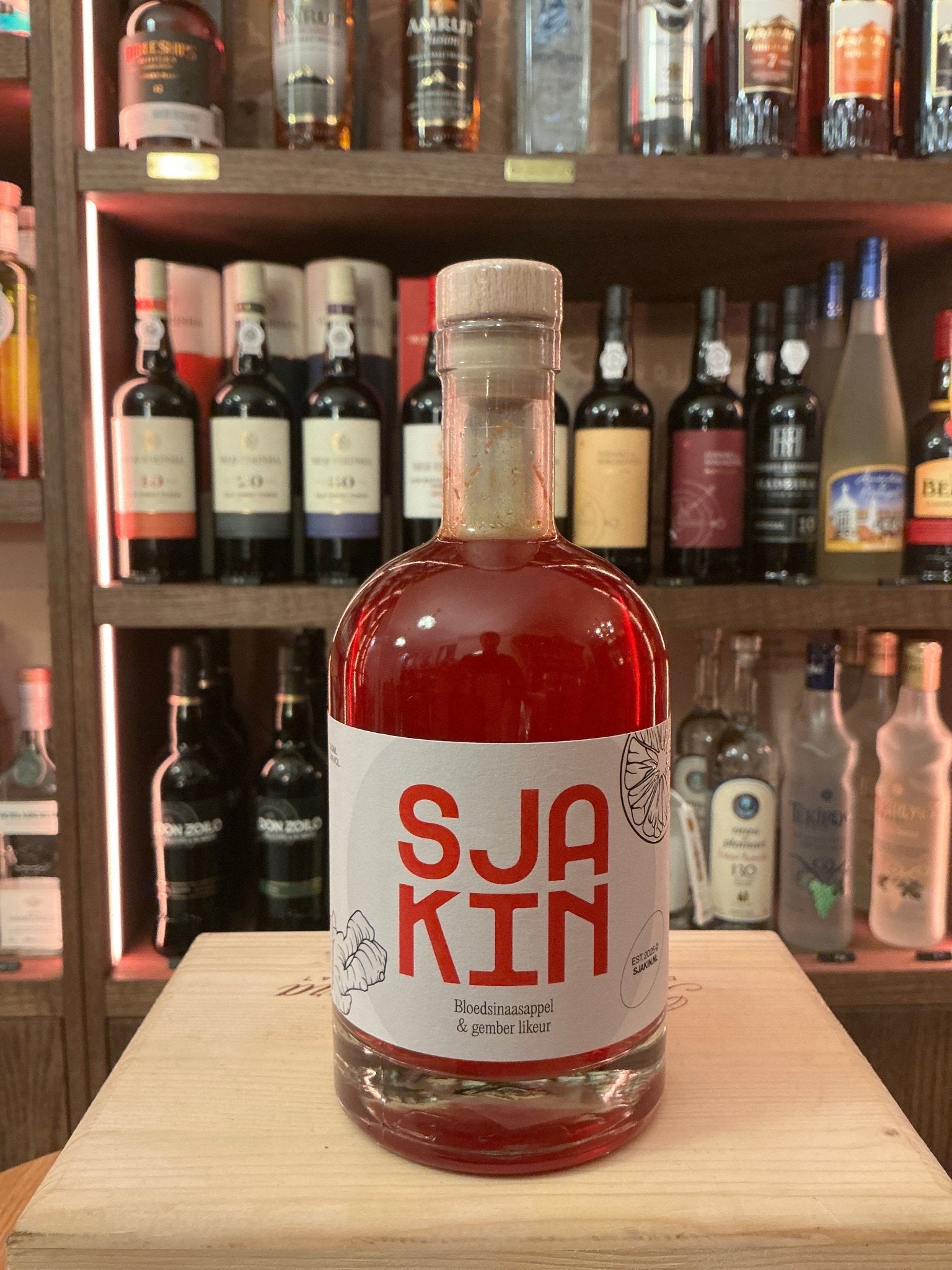SJAKIN Blood Orange & Ginger Liqueur bottle with bold red and white label, artisan Dutch spiced liqueur, premium small-batch .