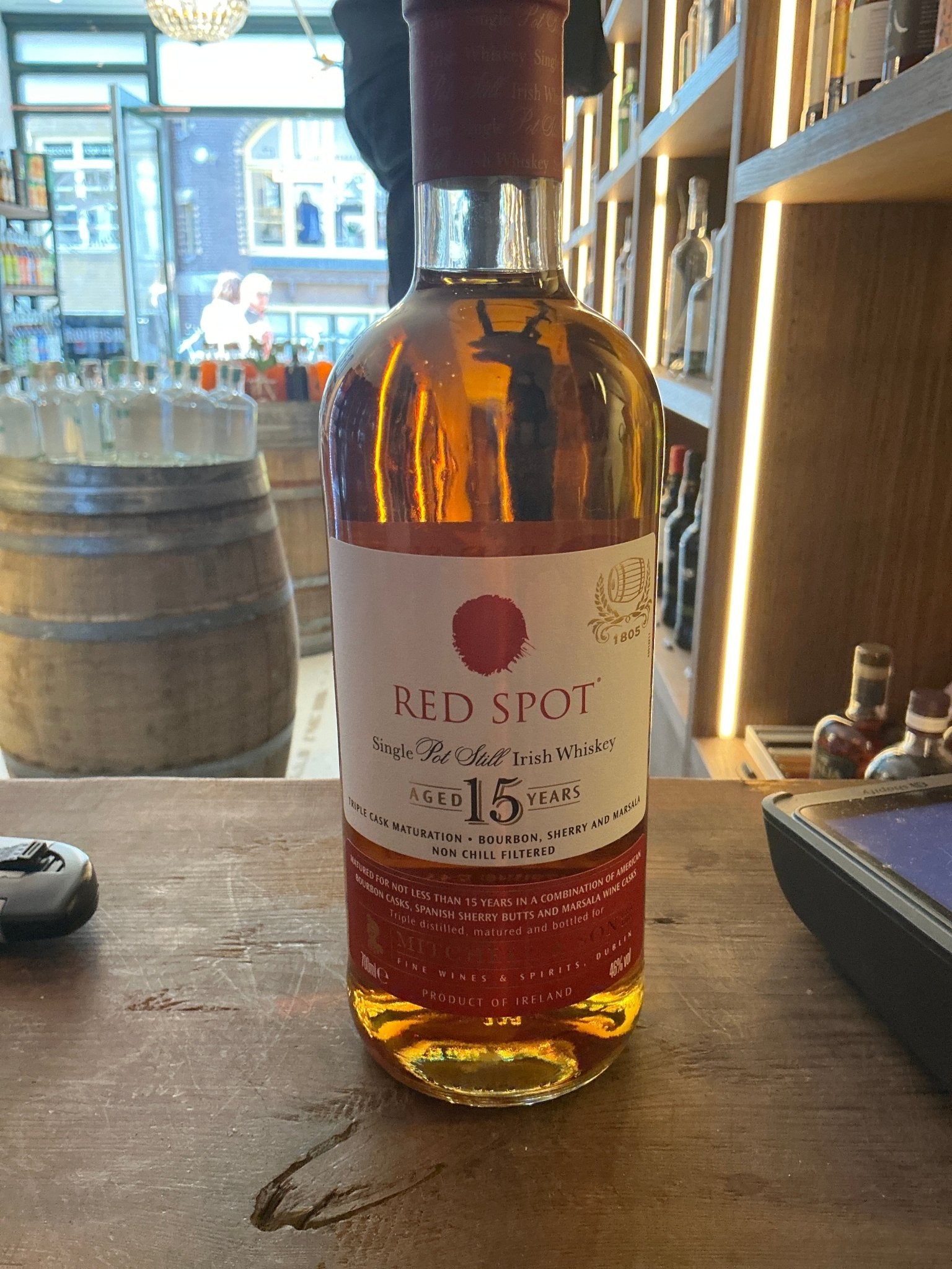 Red Spot 15-year aged Irish whiskey bottle with premium distilled amber liquid, small batch artisan spirit.