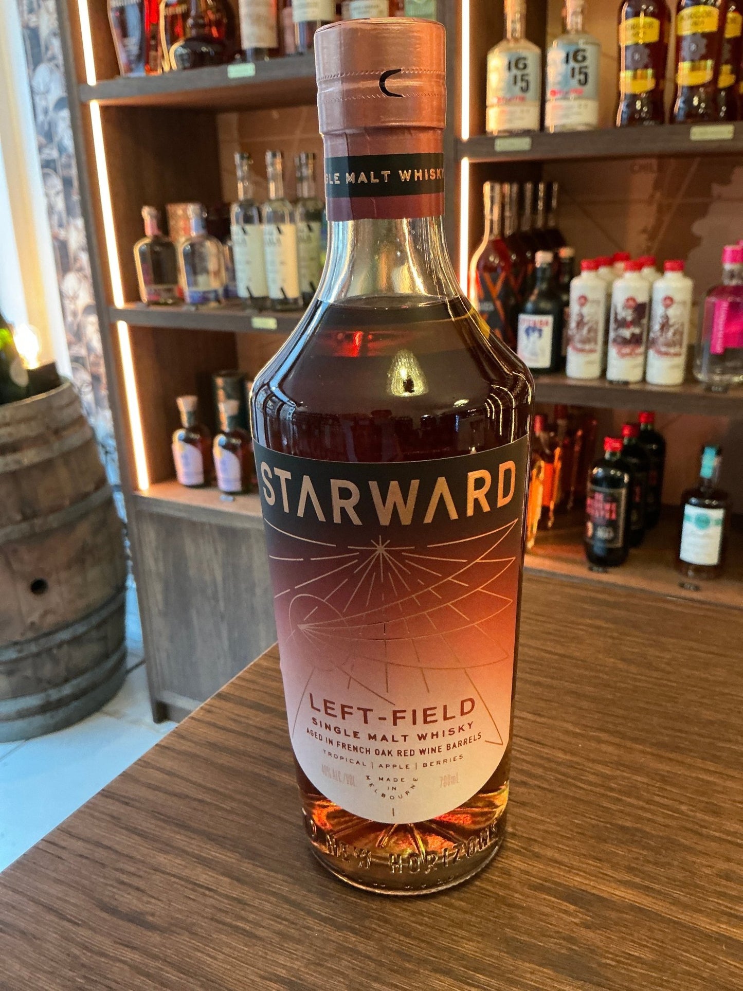 Starward Left-Field Single Malt whisky bottle with amber liquid, premium aged distilled artisan spirit, botanical and spiced .