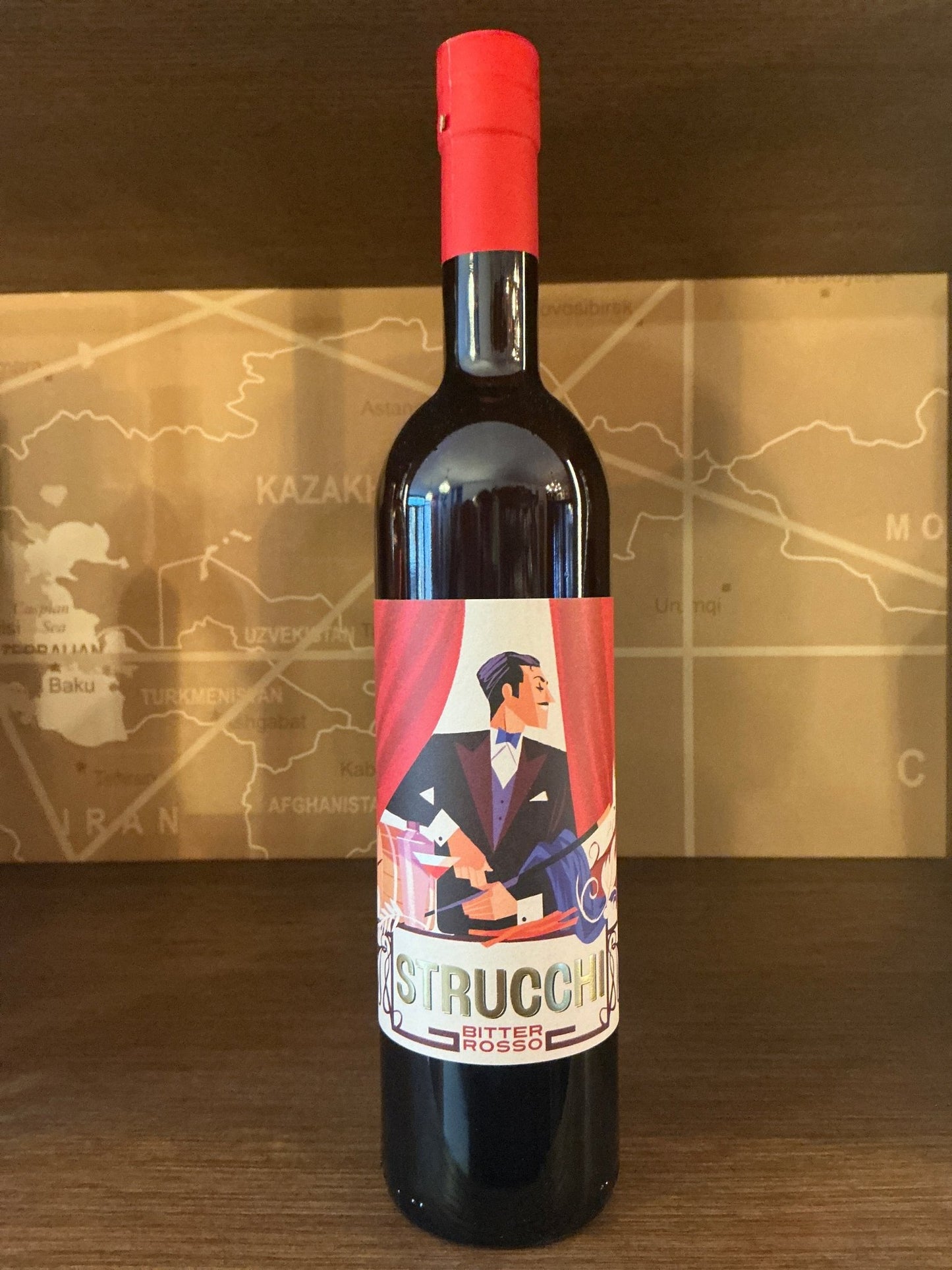 Strucchi Bitter Rosso bottle with red cap, artisanal Dutch craft spirit, premium limited edition gift, featuring stylized.