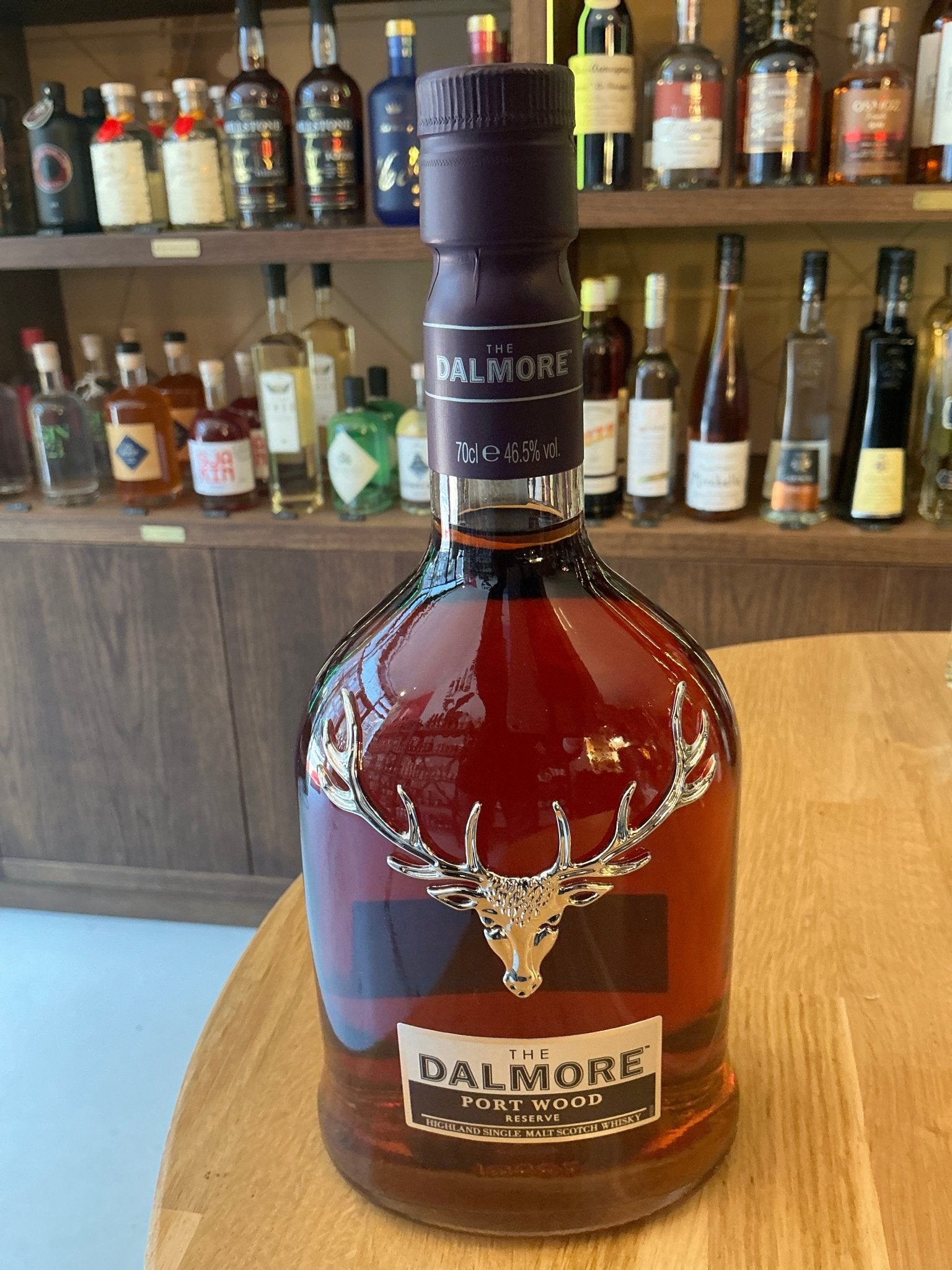 Premium Dalmore Portwood Reserve single malt Scotch whisky in a distinctive clear glass bottle with embossed stag emblem,.