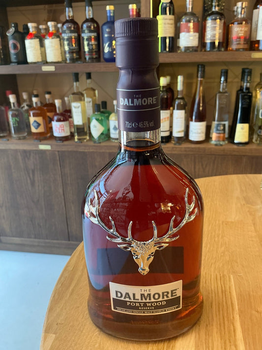 Premium Dalmore Portwood Reserve single malt Scotch whisky in a distinctive clear glass bottle with embossed stag emblem,.