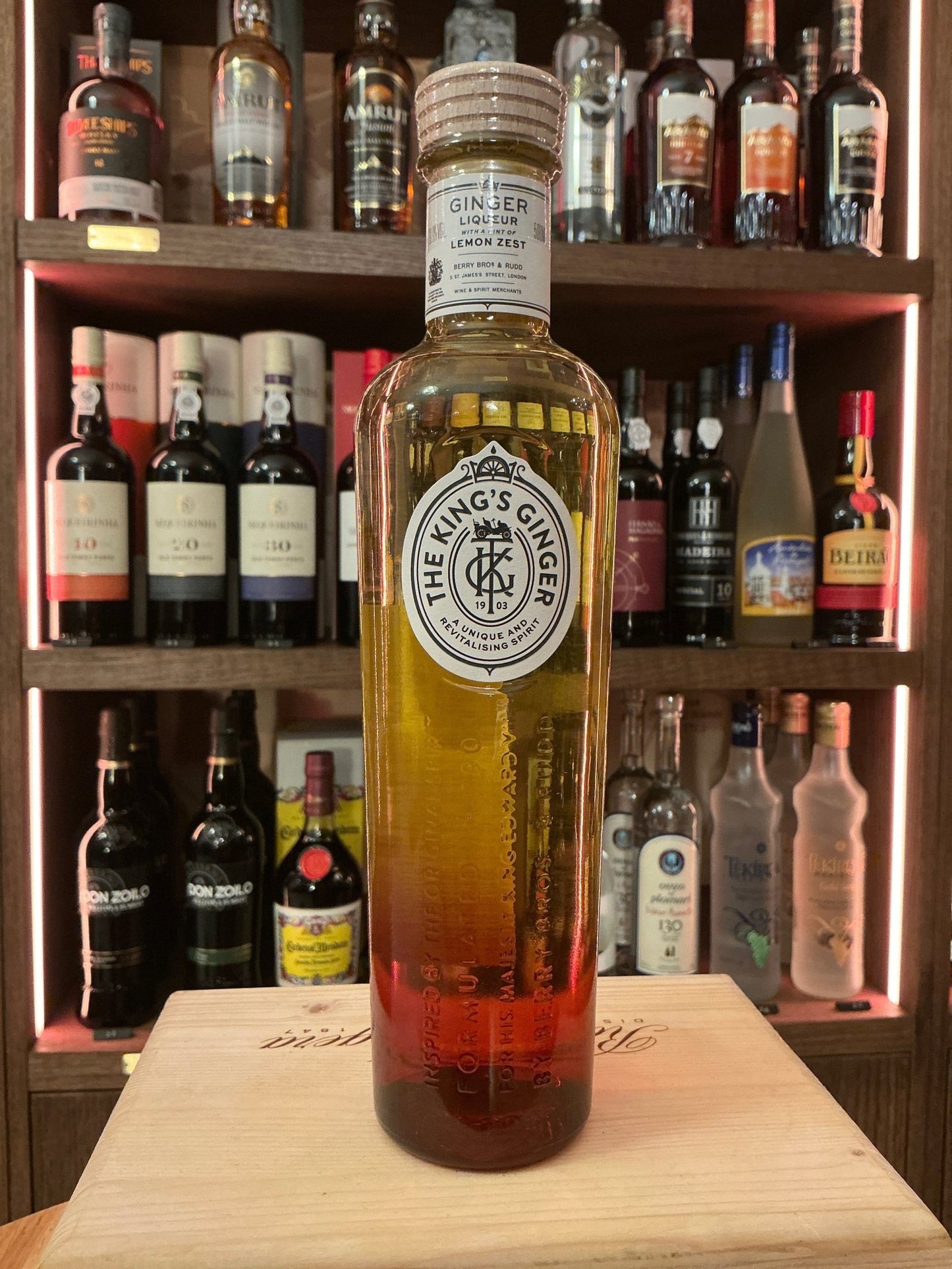 The King’s Ginger Liqueur bottle with amber to red gradient, botanical and spiced premium liqueur, artisan small batch.