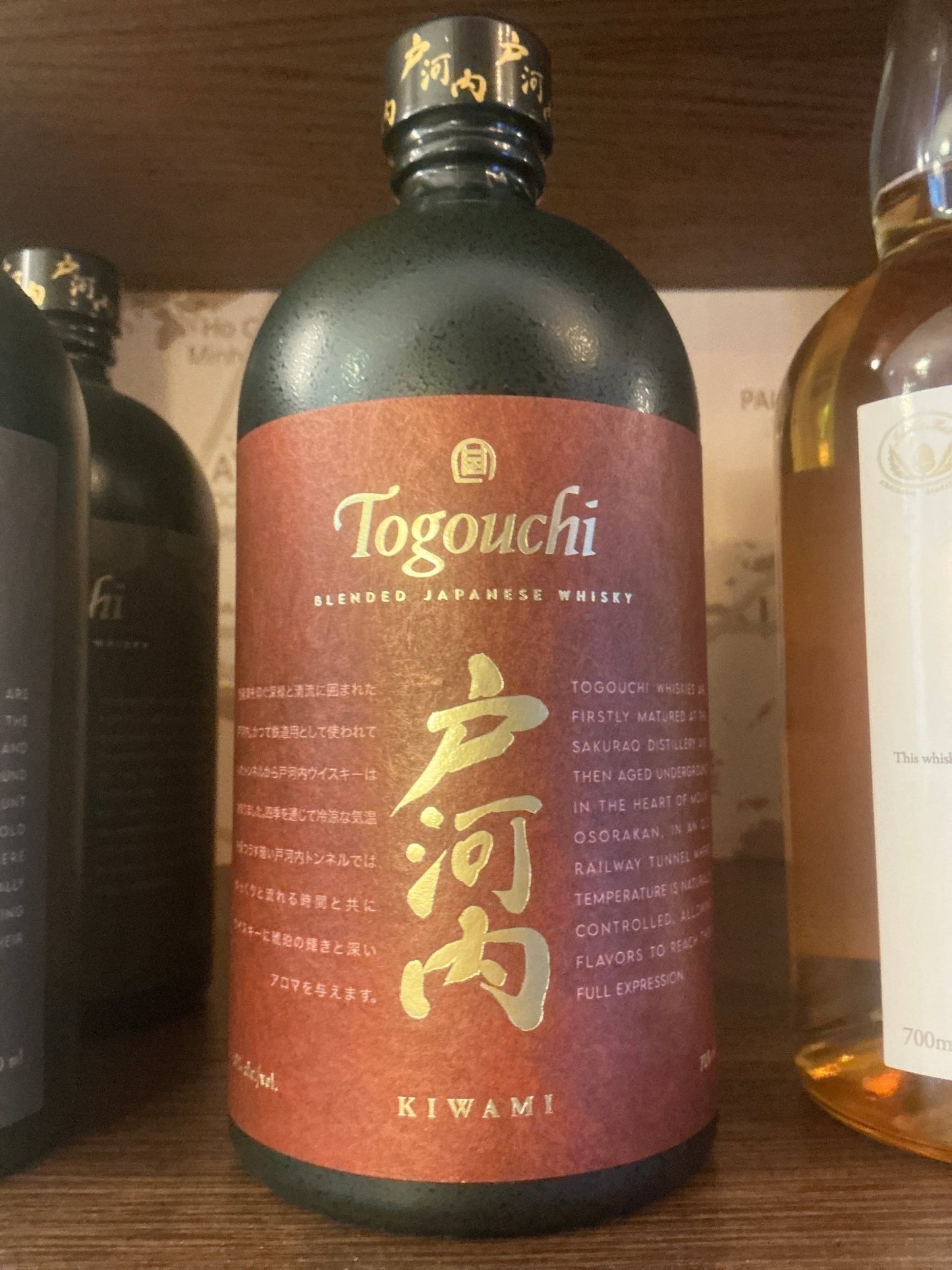 Togouchi Kiwami Japanese blended malt whisky bottle with matte black cap and red label featuring gold Japanese characters,.