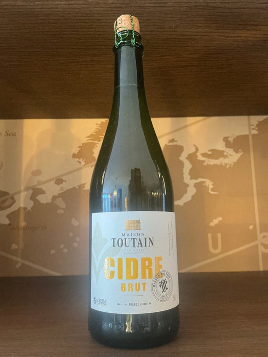 Maison Toutain Cidre Brut 750ml dark green bottle with cork and white label — traditional Norman farmhouse cider, bottle fermented, Normandy France, 4% ABV