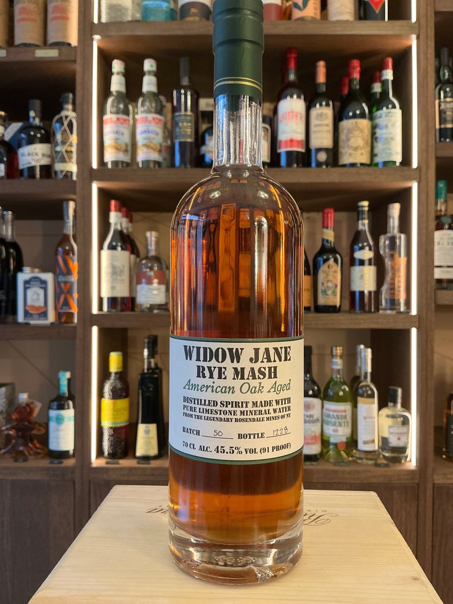Widow Jane Rye Mash American whiskey bottle with amber liquid, white label, green cap, premium small batch artisan rye.