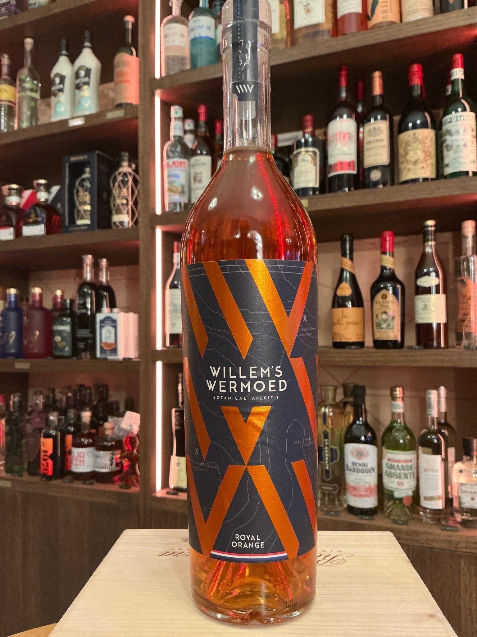Tall bottle of Willem's Wermoed Royal Orange Dutch vermouth with spiced, botanical amber liquid, artisan craft spirits label.