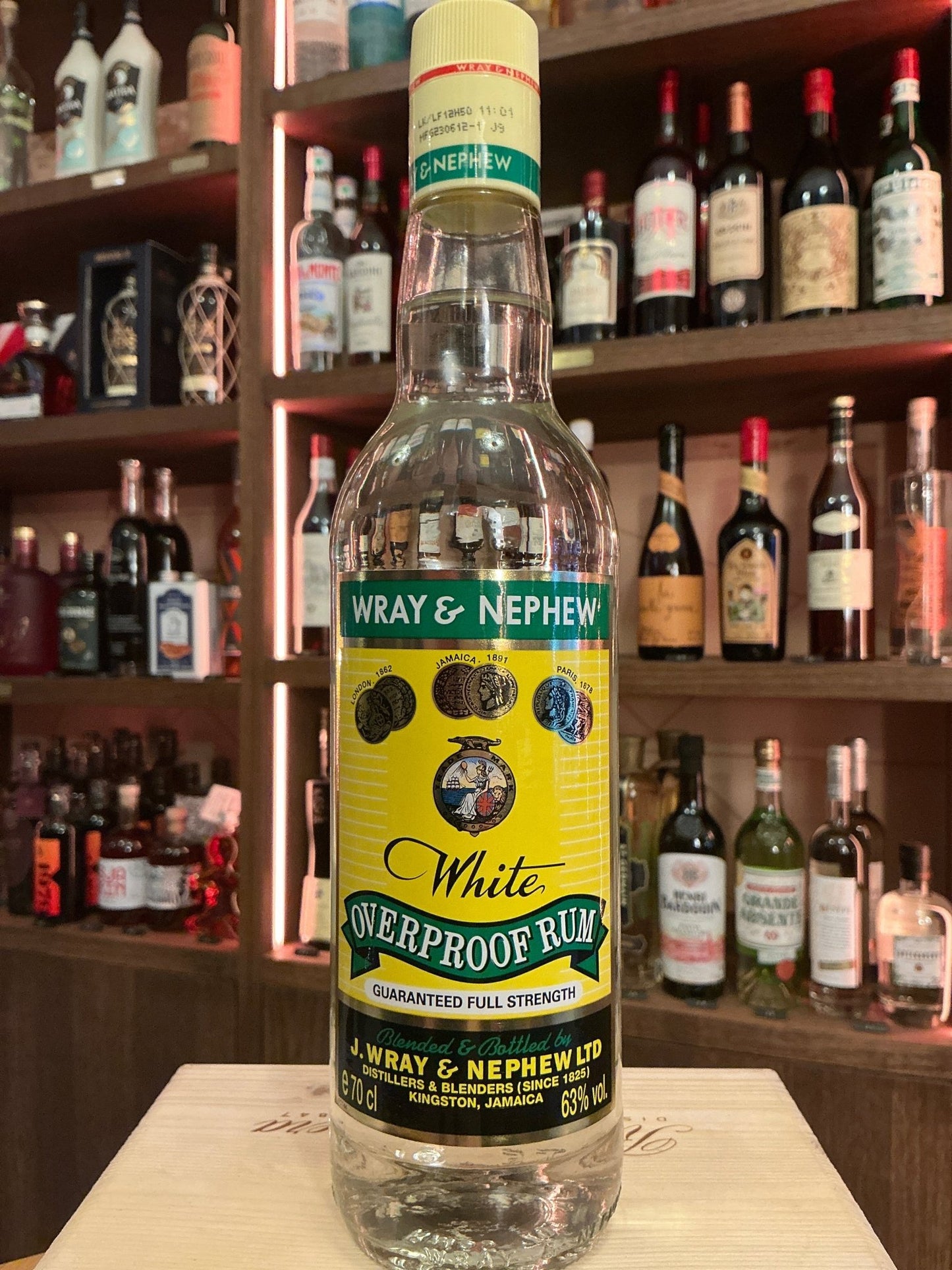 Wray & Nephew Overproof Rum bottle with bright yellow label, premium Jamaican overproof aged rum, artisan distilled and.