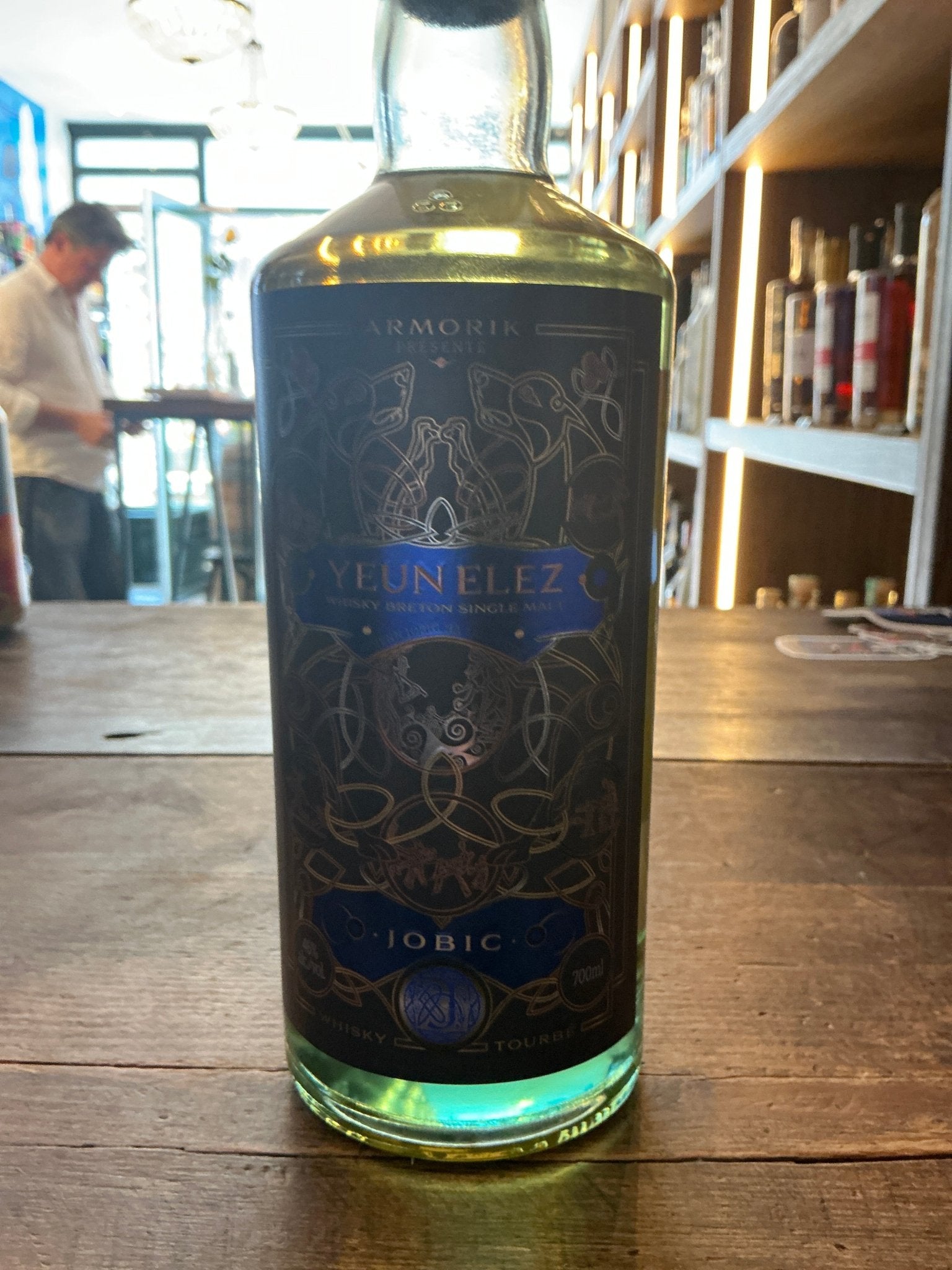 Yeun Elez Breton Single Malt Whisky bottle with intricate blue and gold label, premium aged distilled spirit, artisan French .
