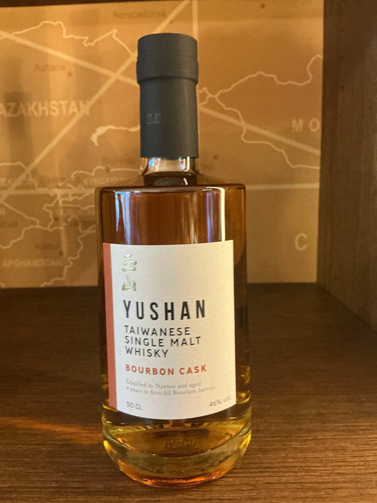 Yushan Bourbon Cask Single Malt Taiwanese whisky bottle with premium artisanal label on wooden shelf, limited edition gift.