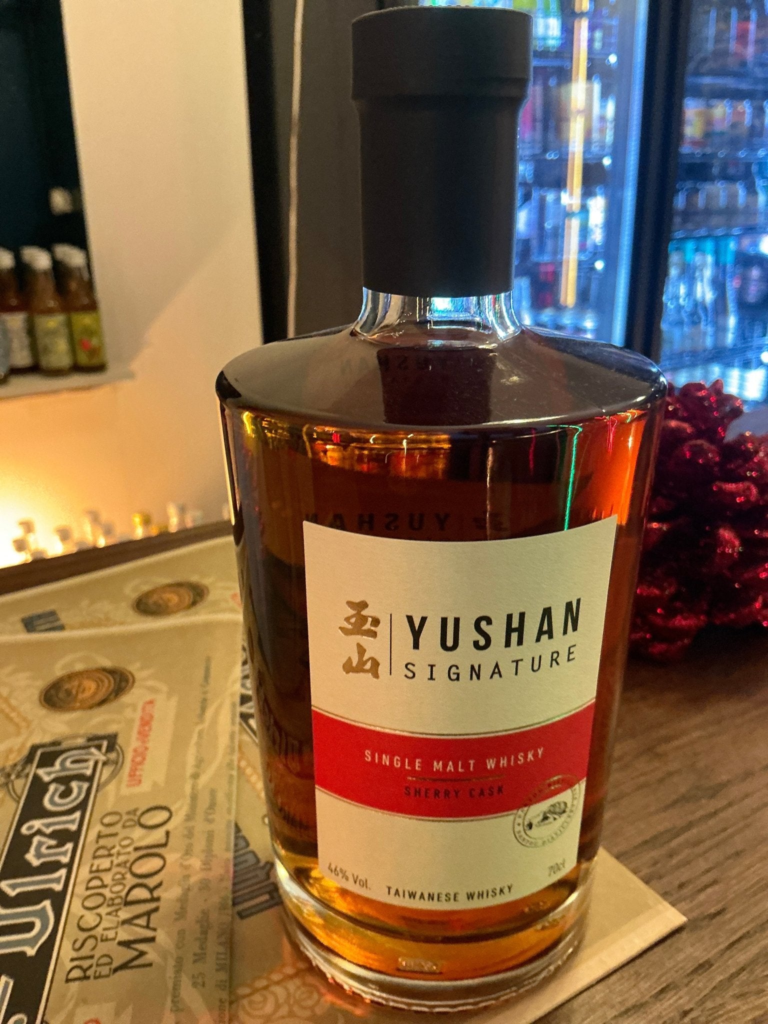 Yushan Signature Sherry Cask Single Malt whisky bottle with rich amber liquid, artisanal Taiwanese craft spirit aged in.